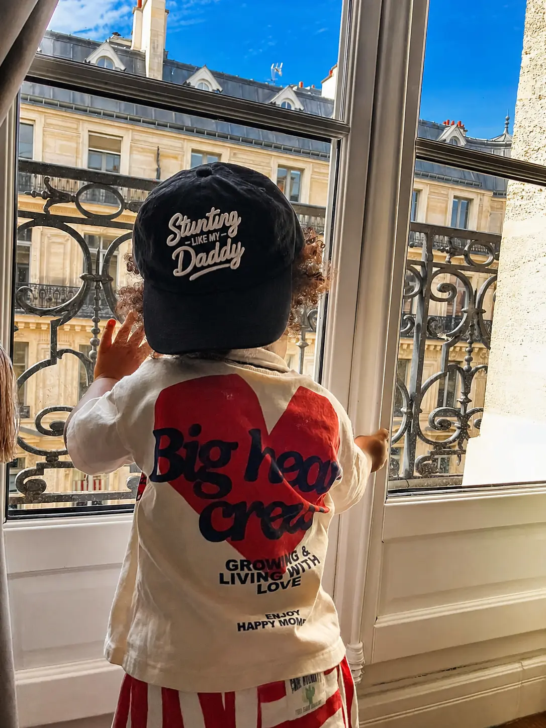 A child exploring Paris in their Legacy Team hat, scene 2