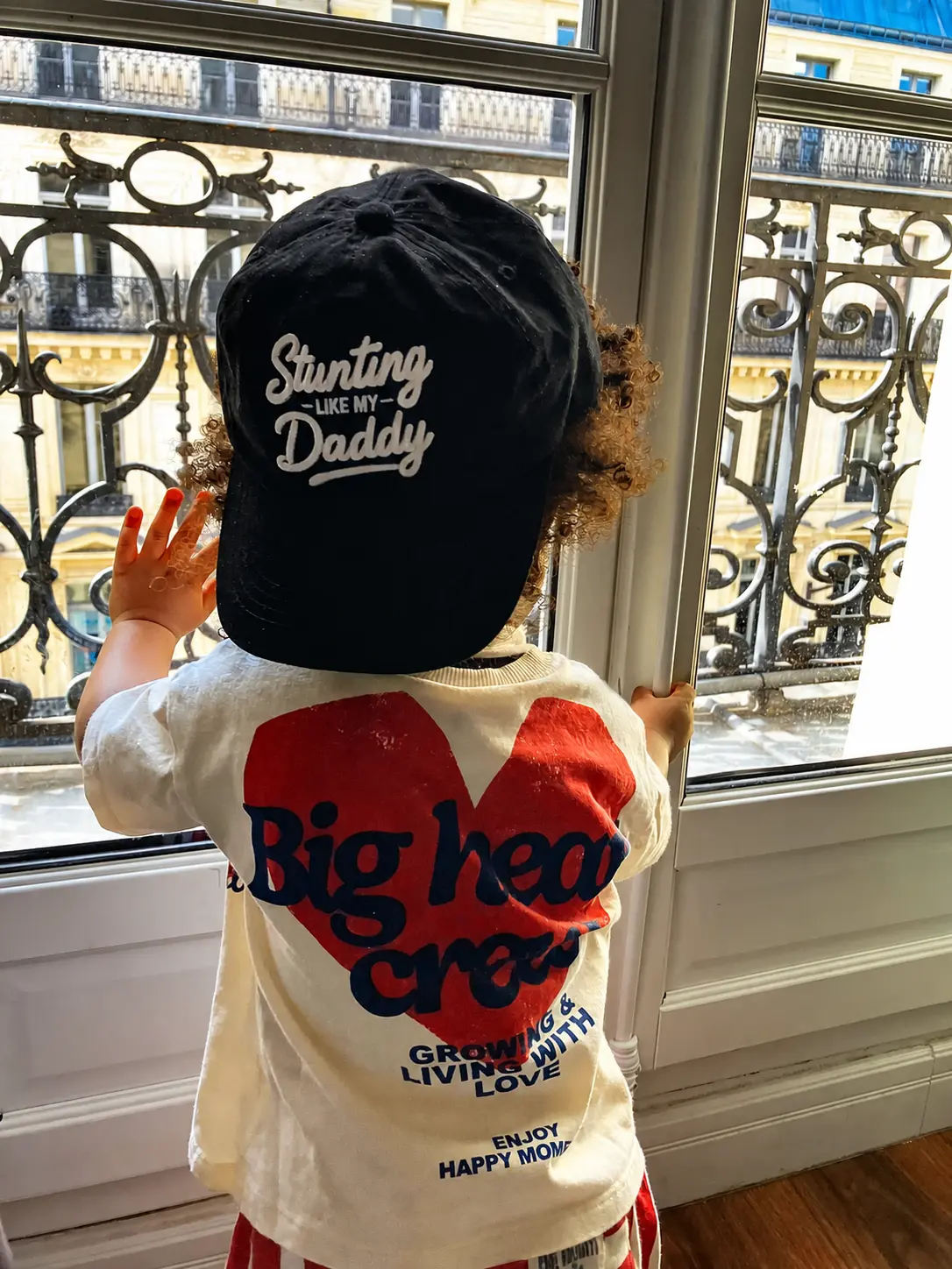 A child exploring Paris in their Legacy Team hat, scene 3